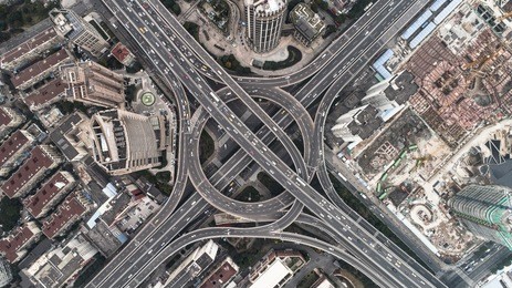 aerial view of highway and overpass in city on a cloudy day