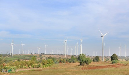 landscape view of hills and windmills. wind turbines for electric power production on mountain.