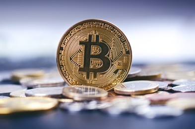 golden bitcoin coins on a dark background with euro coins.  virtual currency. crypto currency. new virtual money. lens flare 