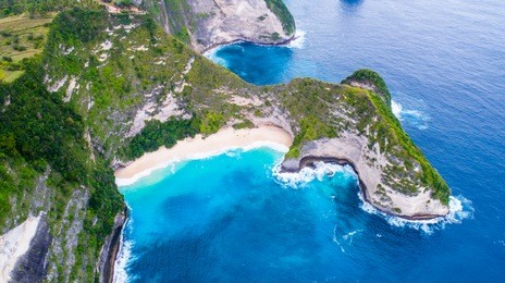 an aerial view of island and beach in bali, indonesia.
