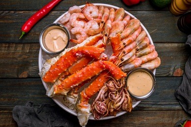 platter of shrimp, king crab and squid on the ice