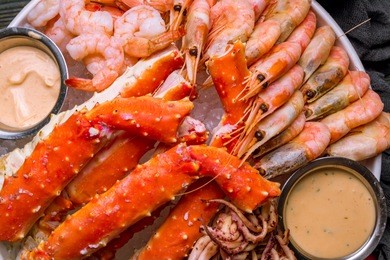 platter of shrimp, king crab and squid on the ice