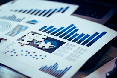 four pieces of jigsaw puzzle on lay on data report of businessman table for business solution and success concept,selective focus