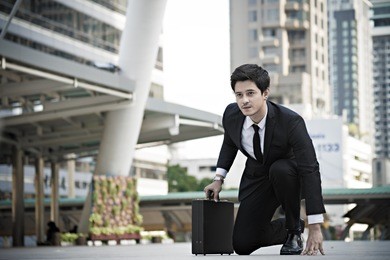 business handsom man just start acting.he bring black bag in his hand and look forward. 