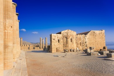 columns of portico and church of st. john on the acropolis of lindos (rhodes, greece)