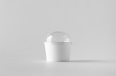 white ice cream paper cup mock-up with plastic lid.