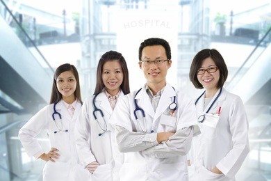 asian medical team standing inside hospital building