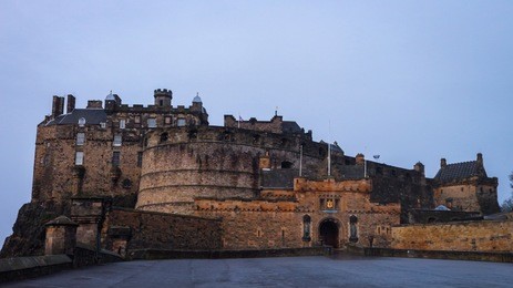 the famous edinburgh castle and its esplanade shortly after sunrise. the shot was taken in january 2018.