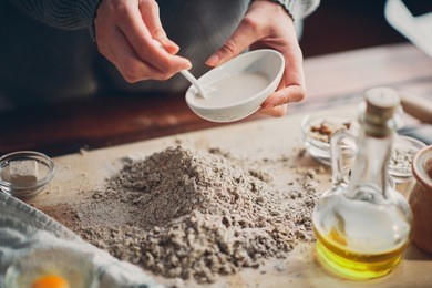 close up of woman`s hands making a bread.