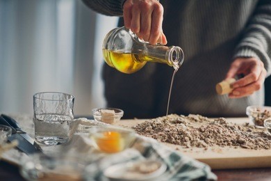 close up of woman`s hands making a bread.