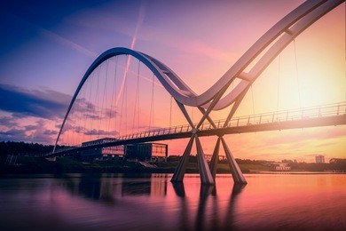 infinity bridge on dramatic sky at sunset in stockton-on-tees, uk.