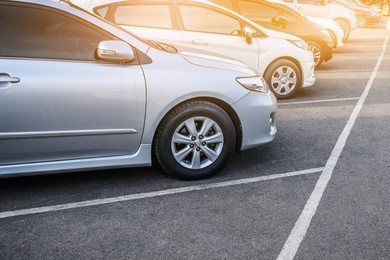 car parked row on road,car a lot parking in line and sunset