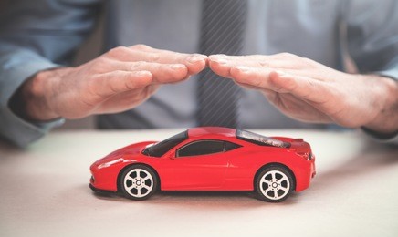 man protect red car. car insurance concept.