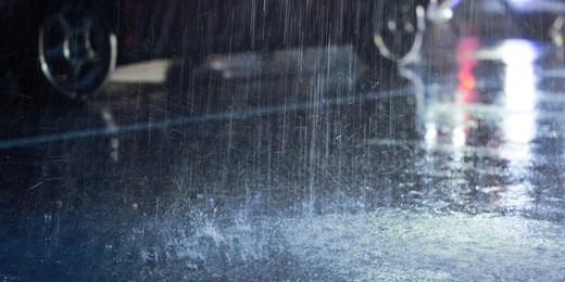 hard rain fall at night with blurry cars .selective focus.