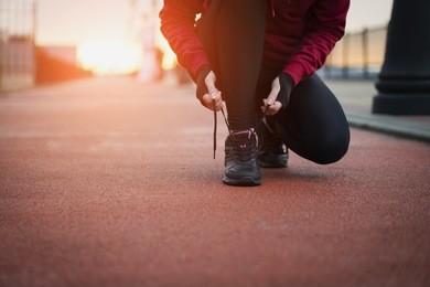 the runner woman ties the shoelaces before running. healthy lifestyle