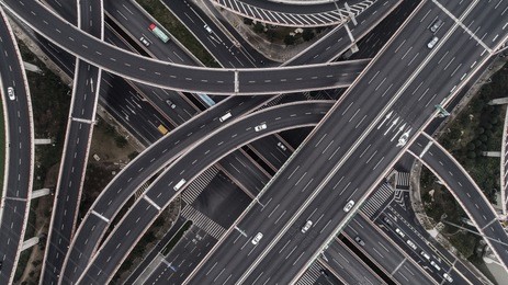aerial view of highway and overpass in city on a cloudy day