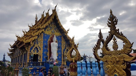 wat rong sua ten or the blue temple in chiang rai, thailand. new architectural renovation with overcast sky.