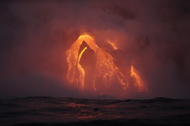the hot lava of the hawaiian volcano kilauea flows into the waters of the pacific ocean