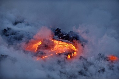 the hot lava of the hawaiian volcano kilauea flows into the waters of the pacific ocean