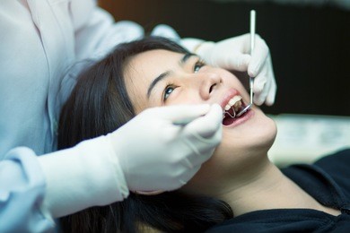 overview of dental caries prevention.woman at the dentist's chair during a dental procedure. beautiful asian woman smile close up. healthy smile. beautiful female smile