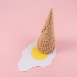 ice cream cone with paper fried egg. minimal concept.