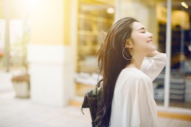 summer sunny lifestyle fashion portrait of young stylish hipster asia woman walking on the street, wearing cute trendy outfit