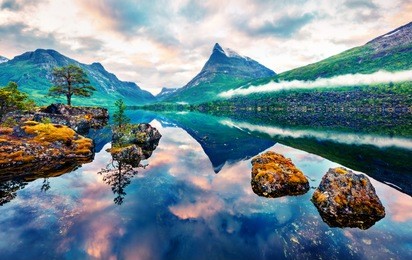unbelievable summer sunrise on innerdalsvatna lake. colorful morning scene in norway, europe. beauty of nature concept background. artistic style post processed photo. orton effect.