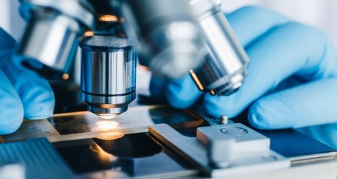close-up shot of microscope with metal lens at laboratory.