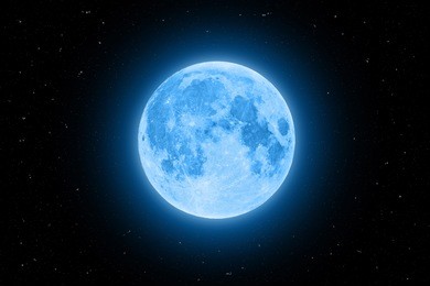 blue super moon glowing with blue halo surrounded by stars on black sky background
