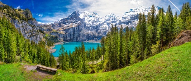 amazing tourquise oeschinnensee with waterfalls and swiss alps, kandersteg, berner oberland, switzerland.
