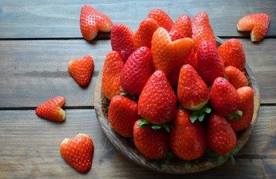 fresh strawberry and strawberry heart in wooden  plate on wooden background,concept valentine's day