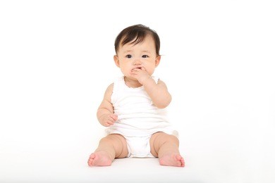 cute baby girl sitting on white background