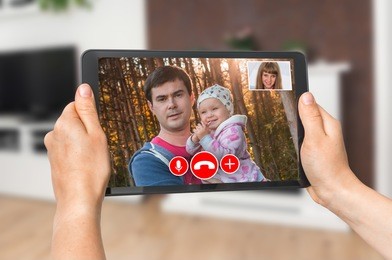 woman online talking with her family - video call concept