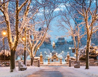 view of boston in massachusetts, usa in the winter season at commonwealth avenue with snow and christmas lights.