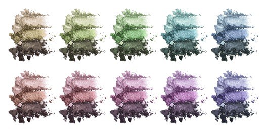 a huge set of multi-colored triple eye shadow. crushed eyeshadow. closeup of a makeup product.