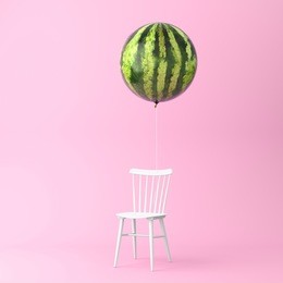 balloon watermelon with chair concept on pastel pink background. minimal idea food and fruit concept. an idea creative to produce work within an advertising marketing communications or artwork design.