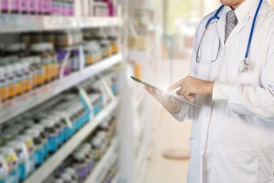 pharmacist use tablet to drug store management. pharmacist 4.0 technology for stock management for pharmacy. technology for drug store business concept.
