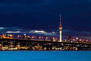 the wonderful city of auckland a night with the sky tower lights.