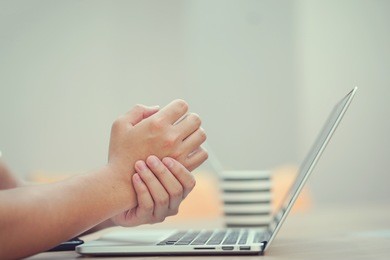 close up employee man massage on his hand and arm for relief pain from hard working ,carpal tunnel syndrome concept