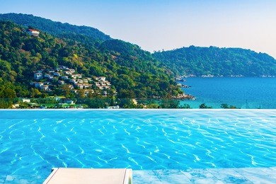 beautiful view from the roof of the hotel with a swimming pool at kata noi bay in the evening, phuket, thailand 