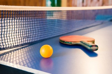 table tennis - racket, ball, table. tabletennis or ping pong rackets and yellow balls on blue table. sport concept. table tennis