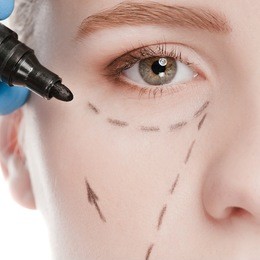 beautician touch and draw correction lines on woman face. before plastic surgery operetion. isolated on white
