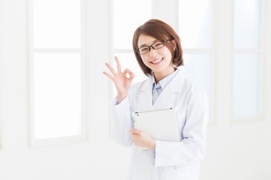 young attractive asian woman in a white coat, tablet computer
