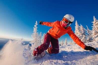 snowboarder on snowboard rides through snow, explosion. freeride snowboarding in sheregesh ski resort