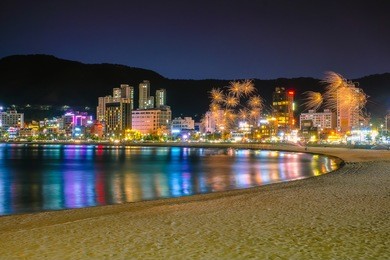 haeundae beach in busan city at night, south korea. image contain of dust and noise. 