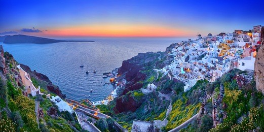 fira town on santorini island, greece. incredibly romantic sunset on santorini. oia village in the morning light. amazing sunset view with white houses. island lovers. panorama of the bay.