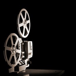old film projector on a black backgroun