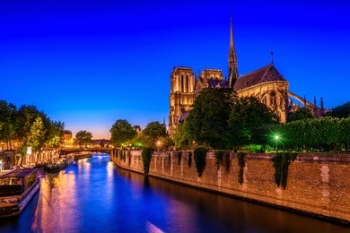 night view of cathedral notre dame de paris and river seine in paris, france. architecture and landmarks of paris. postcard of paris