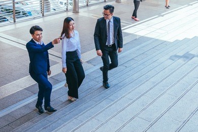 young business team walking in city for going to work with cityscape background.