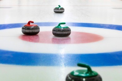 curling stones on the ice